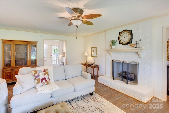 1828 Independence Sq, Kannapolis, NC 28081 - living room featuring wood finished floors, crown molding, a ceiling fan, and a brick fireplace