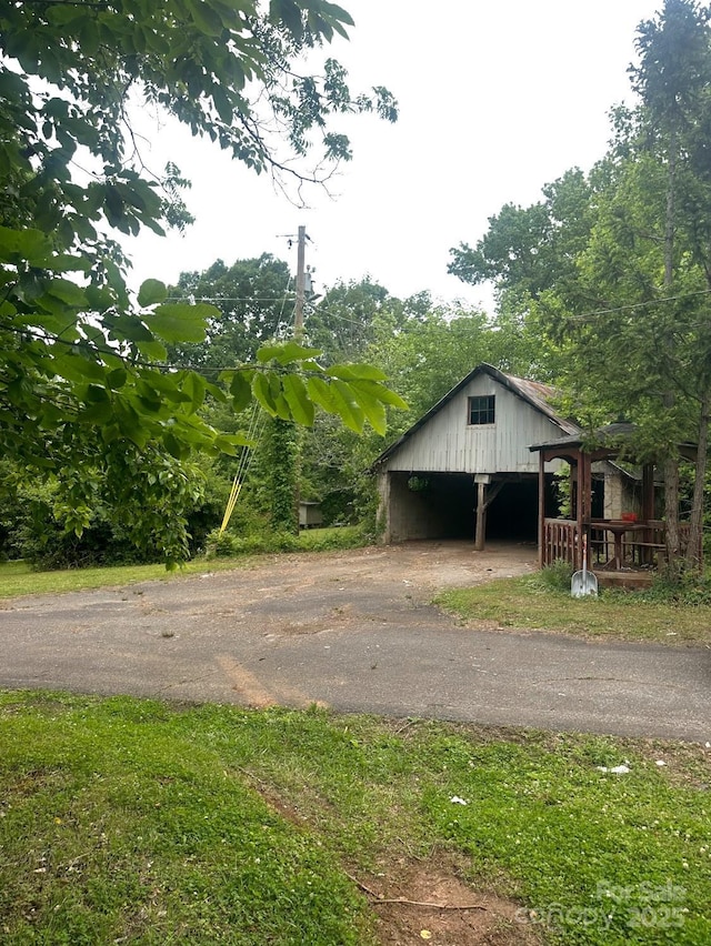 2870 Rutherford College Rd, Connelly Springs, NC 28612 - garage featuring asphalt driveway and a carport