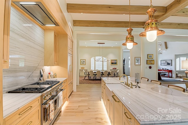 2632 Bartram Pl, Winston Salem, NC 27106 - kitchen with high end range, a spacious island, light wood-type flooring, beam ceiling, and a breakfast bar area