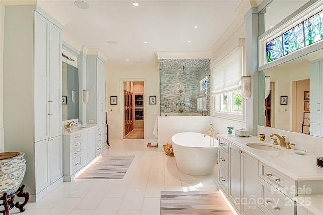 2632 Bartram Pl, Winston Salem, NC 27106 - full bath featuring two vanities, a freestanding bath, a walk in shower, tile patterned flooring, and recessed lighting