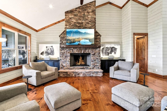 71 Raptor Way, Sapphire, NC 28774 - living area featuring wood walls, wood-type flooring, a fireplace, and high vaulted ceiling