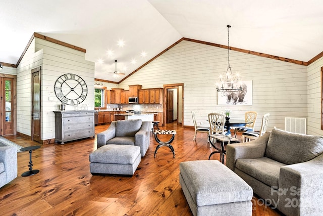 71 Raptor Way, Sapphire, NC 28774 - living area with lofted ceiling, wood walls, a chandelier, dark wood-style floors, and healthy amount of natural light