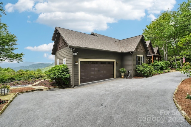 71 Raptor Way, Sapphire, NC 28774 - view of side of home with asphalt driveway, a shingled roof, a garage, and a mountain view