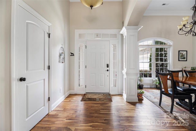 233 Highland Forest Dr, Clover, SC 29710 - foyer featuring decorative columns, wood finished floors, a high ceiling, crown molding, and a chandelier