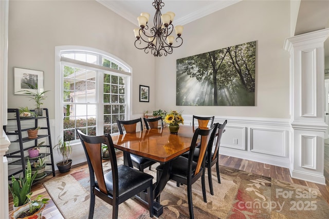 233 Highland Forest Dr, Clover, SC 29710 - dining space with crown molding, decorative columns, wood finished floors, and a chandelier