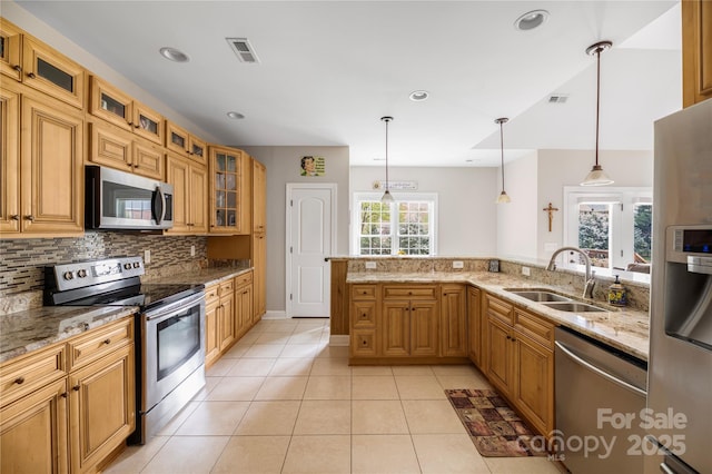233 Highland Forest Dr, Clover, SC 29710 - kitchen with stainless steel appliances, decorative backsplash, light stone counters, pendant lighting, and light tile patterned floors