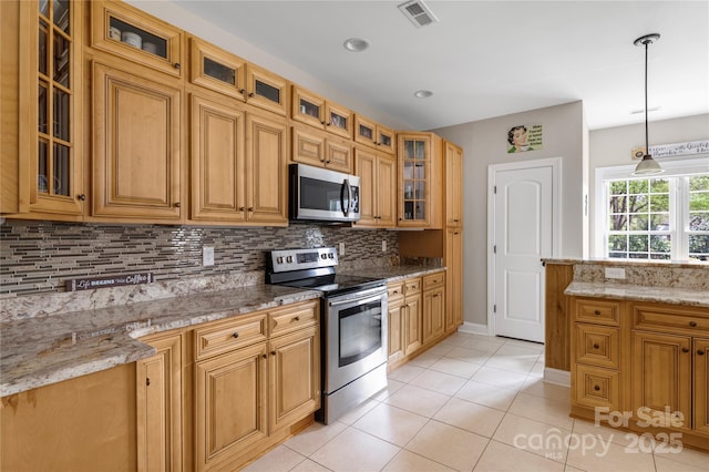 233 Highland Forest Dr, Clover, SC 29710 - kitchen with appliances with stainless steel finishes, decorative backsplash, light tile patterned floors, and light stone counters
