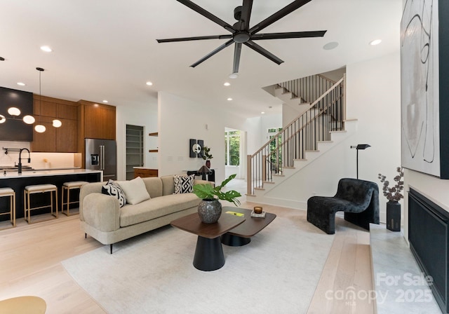 1727 Seifert Cir, Charlotte, NC 28205 - living room featuring a ceiling fan, stairway, recessed lighting, and light wood finished floors