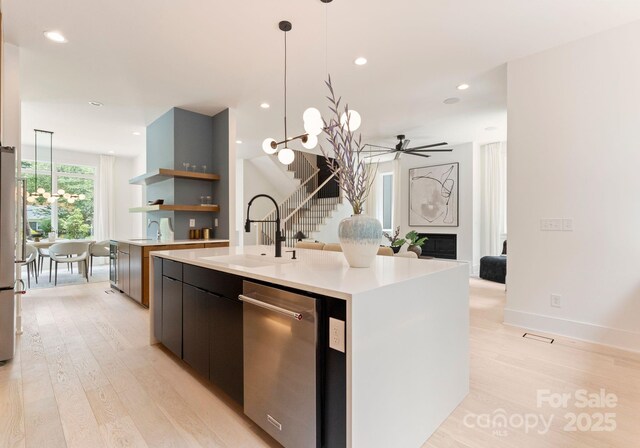 1727 Seifert Cir, Charlotte, NC 28205 - kitchen featuring appliances with stainless steel finishes, light countertops, modern cabinets, light wood-style flooring, and open shelves