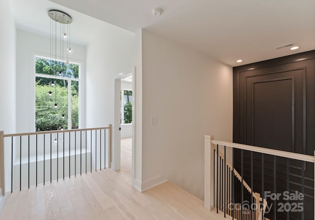 1727 Seifert Cir, Charlotte, NC 28205 - hallway with an upstairs landing, light wood finished floors, and recessed lighting