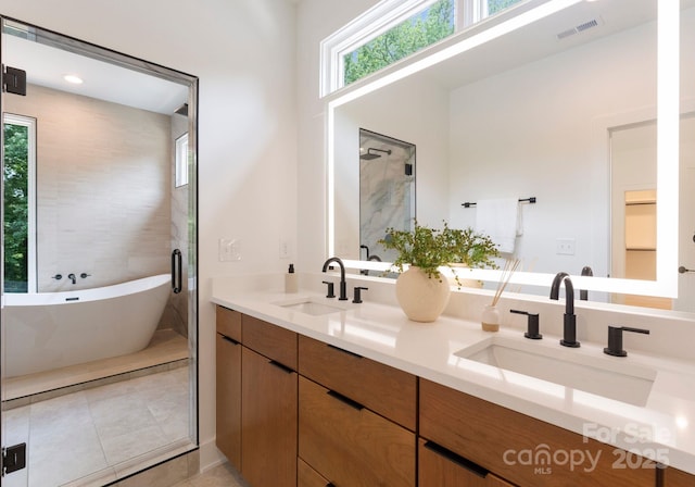 1727 Seifert Cir, Charlotte, NC 28205 - full bath with double vanity, a soaking tub, tile patterned floors, and a stall shower