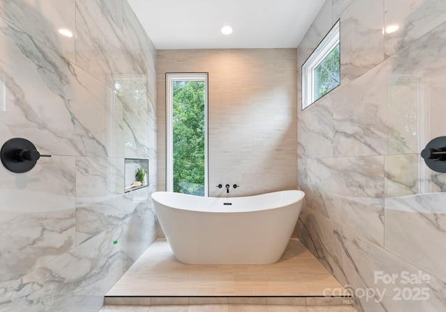 1727 Seifert Cir, Charlotte, NC 28205 - bathroom with tile walls and a freestanding bath