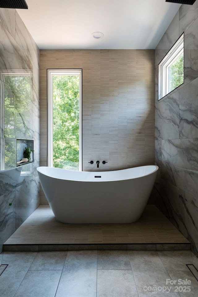 1727 Seifert Cir, Charlotte, NC 28205 - full bathroom featuring a soaking tub, tile patterned flooring, and tile walls