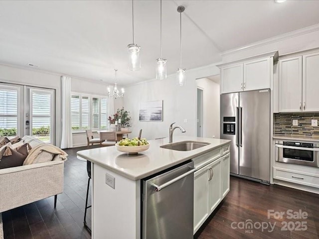 2034 Laney Pond Rd, Matthews, NC 28104 - kitchen with appliances with stainless steel finishes, ornamental molding, a chandelier, light countertops, and open floor plan