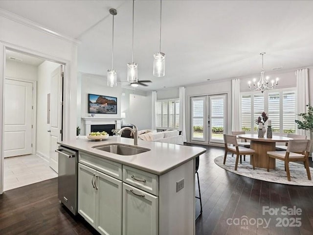 2034 Laney Pond Rd, Matthews, NC 28104 - kitchen featuring stainless steel dishwasher, a fireplace, a center island with sink, open floor plan, and light countertops