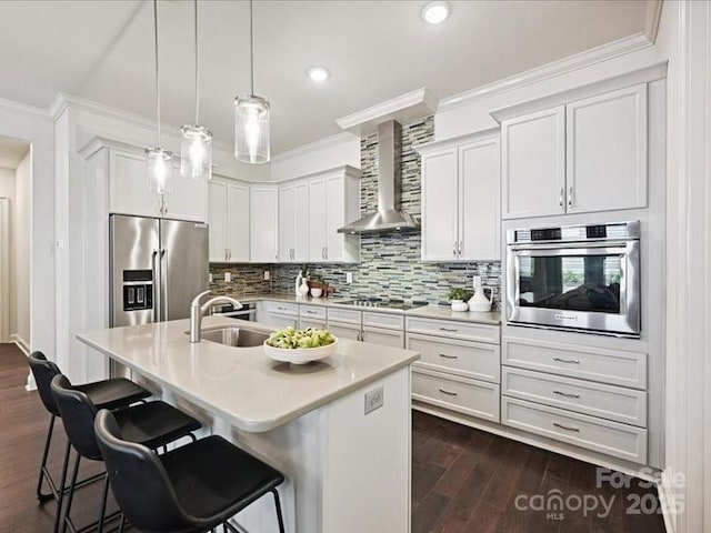 2034 Laney Pond Rd, Matthews, NC 28104 - kitchen with stainless steel appliances, wall chimney exhaust hood, crown molding, a kitchen bar, and light countertops