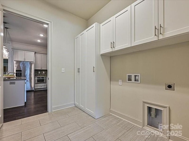 2034 Laney Pond Rd, Matthews, NC 28104 - washroom with hookup for an electric dryer, washer hookup, light wood-style floors, cabinet space, and recessed lighting