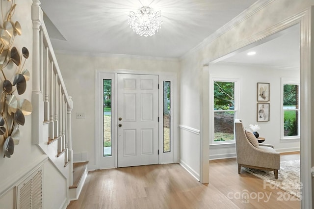 6542 Cross Field Ln, Charlotte, NC 28226 - entryway featuring stairway, light wood-type flooring, a chandelier, and crown molding