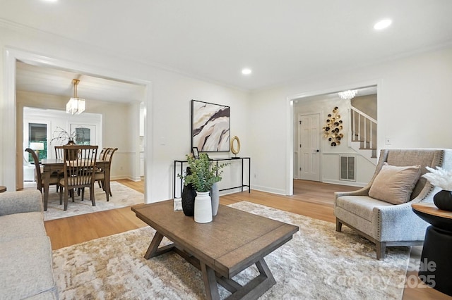 6542 Cross Field Ln, Charlotte, NC 28226 - living area featuring stairs, a chandelier, light wood finished floors, and recessed lighting