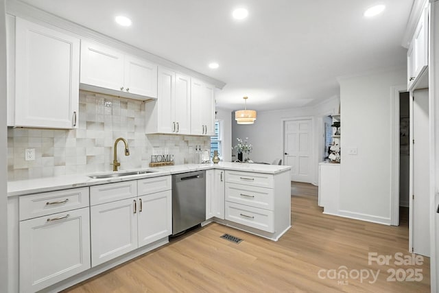 6542 Cross Field Ln, Charlotte, NC 28226 - kitchen with stainless steel dishwasher, a peninsula, white cabinetry, light wood-style floors, and recessed lighting