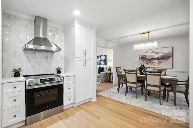 6542 Cross Field Ln, Charlotte, NC 28226 - kitchen featuring electric stove, wall chimney range hood, light wood-style floors, decorative backsplash, and light countertops