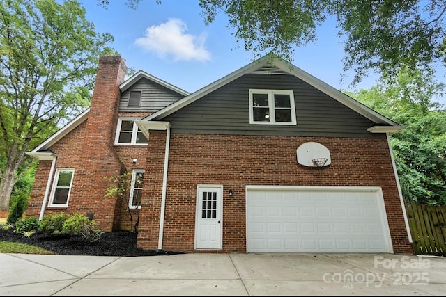 6542 Cross Field Ln, Charlotte, NC 28226 - view of side of home featuring a chimney, driveway, brick siding, and a garage