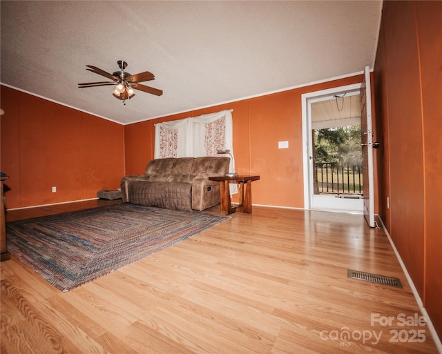8221 Feather Run Rd, Kershaw, SC 29067 - living area with a ceiling fan, wood finished floors, vaulted ceiling, and ornamental molding