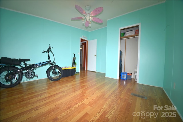 8221 Feather Run Rd, Kershaw, SC 29067 - exercise area featuring wood finished floors, crown molding, and ceiling fan