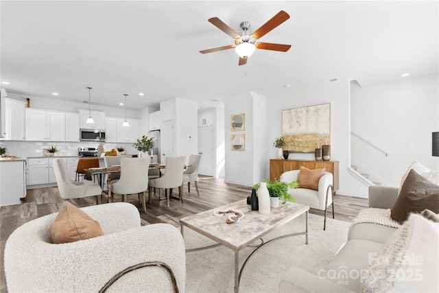 167 Dry Dock Loop, Mooresville, NC 28117 - living area featuring a ceiling fan, light wood finished floors, recessed lighting, and stairway