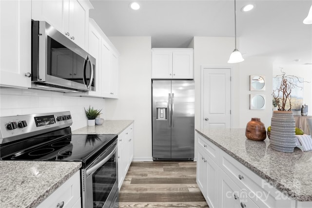 167 Dry Dock Loop, Mooresville, NC 28117 - kitchen with stainless steel appliances, white cabinets, light wood-style flooring, recessed lighting, and decorative backsplash