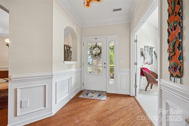 16833 Rudence Ct, Charlotte, NC 28278 - entrance foyer featuring ornamental molding, light wood-type flooring, a wainscoted wall, and a decorative wall