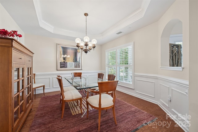 16833 Rudence Ct, Charlotte, NC 28278 - dining area with ornamental molding, a raised ceiling, wood finished floors, a chandelier, and wainscoting