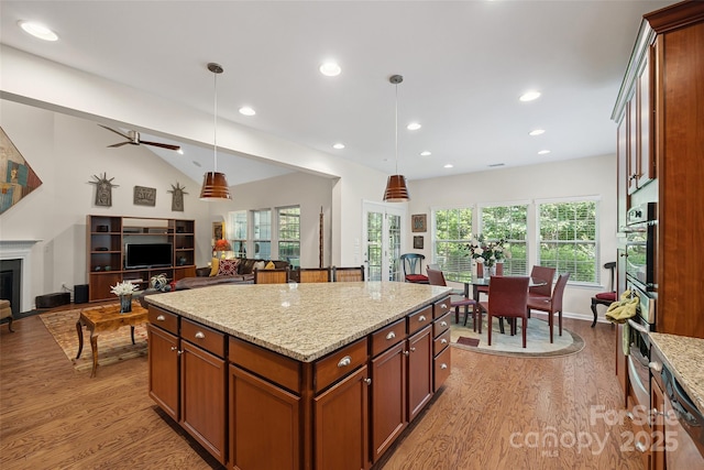 16833 Rudence Ct, Charlotte, NC 28278 - kitchen featuring light wood-style floors, open floor plan, decorative light fixtures, light stone counters, and healthy amount of natural light