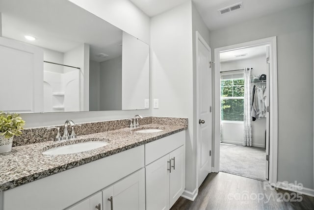280 Mills Creek Rd, Iron Station, NC 28080 - full bath with double vanity, wood finished floors, and a walk in closet