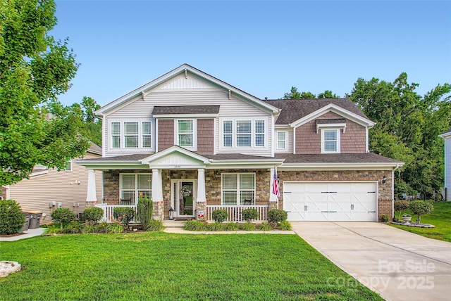 2599 Treeline Dr, Concord, NC 28027 - craftsman-style house featuring concrete driveway, a garage, covered porch, a front yard, and stone siding