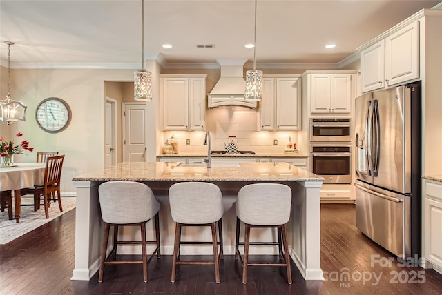 2599 Treeline Dr, Concord, NC 28027 - kitchen with stainless steel appliances, premium range hood, crown molding, dark wood-type flooring, and a breakfast bar