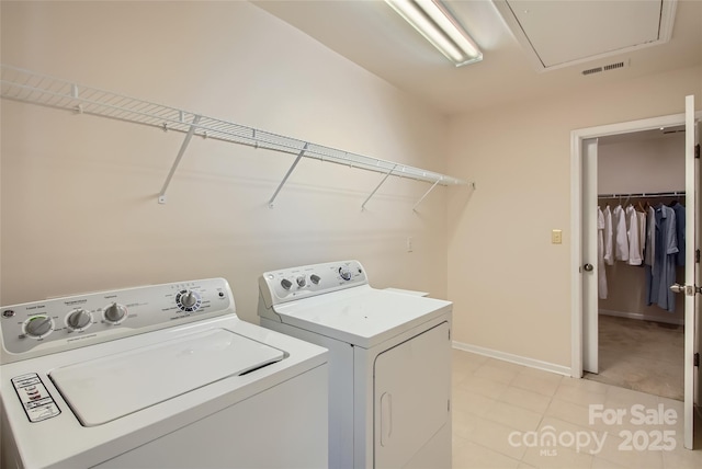 2599 Treeline Dr, Concord, NC 28027 - laundry area featuring separate washer and dryer, attic access, and light tile patterned flooring