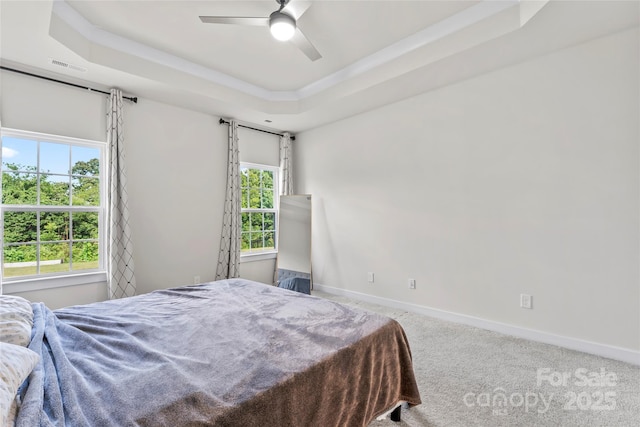1013 Augustus Beamon Dr, Indian Trail, NC 28079 - carpeted bedroom featuring a raised ceiling, multiple windows, and ceiling fan