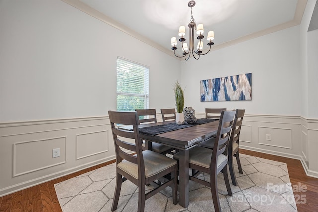 9706 Thyme Ct, Charlotte, NC 28214 - dining room with a chandelier, wood finished floors, wainscoting, and a decorative wall