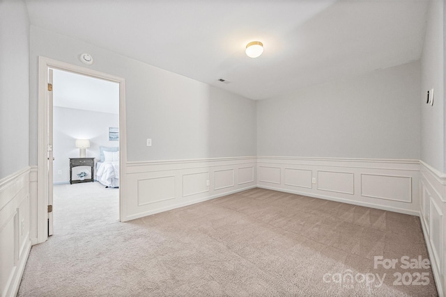9706 Thyme Ct, Charlotte, NC 28214 - carpeted spare room with wainscoting, a decorative wall, and a smoke detector