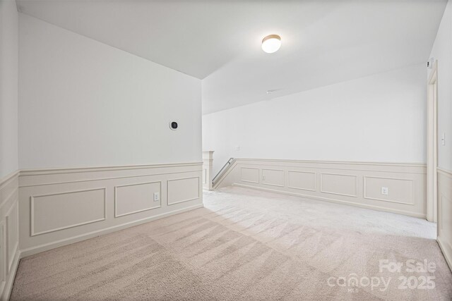 9706 Thyme Ct, Charlotte, NC 28214 - empty room with a decorative wall, carpet floors, and wainscoting