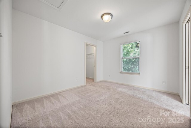 9706 Thyme Ct, Charlotte, NC 28214 - unfurnished bedroom featuring light carpet and a walk in closet