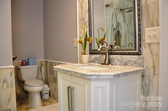 3645 Lake Bluff Dr, Sherrills Ford, NC 28763 - full bathroom featuring a marble finish shower, vanity, tile walls, and wainscoting