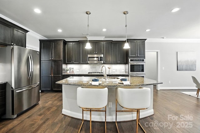 551 Brightleaf Pl NW, Concord, NC 28027 - kitchen with appliances with stainless steel finishes, crown molding, backsplash, a kitchen island with sink, and light stone countertops