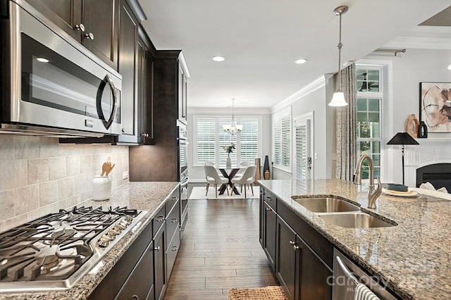 551 Brightleaf Pl NW, Concord, NC 28027 - kitchen with appliances with stainless steel finishes, crown molding, light stone countertops, dark wood-style floors, and tasteful backsplash