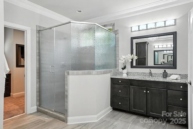 551 Brightleaf Pl NW, Concord, NC 28027 - bathroom with vanity, wood finished floors, a stall shower, and ornamental molding