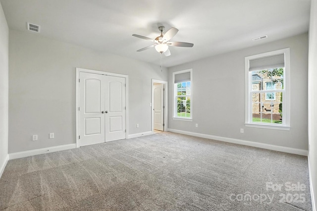 551 Brightleaf Pl NW, Concord, NC 28027 - unfurnished bedroom with carpet floors, a closet, and ceiling fan