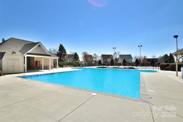 551 Brightleaf Pl NW, Concord, NC 28027 - community pool featuring a patio and an outbuilding