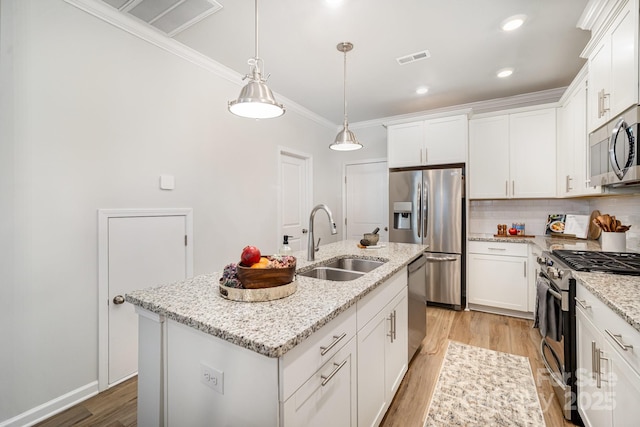 508 Morrows Turnout Way Unit 97, Pineville, NC 28134 - kitchen with stainless steel appliances, light wood-type flooring, crown molding, a center island with sink, and white cabinetry