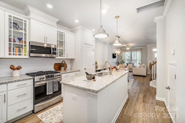 508 Morrows Turnout Way Unit 97, Pineville, NC 28134 - kitchen featuring stainless steel appliances, crown molding, tasteful backsplash, open floor plan, and white cabinetry